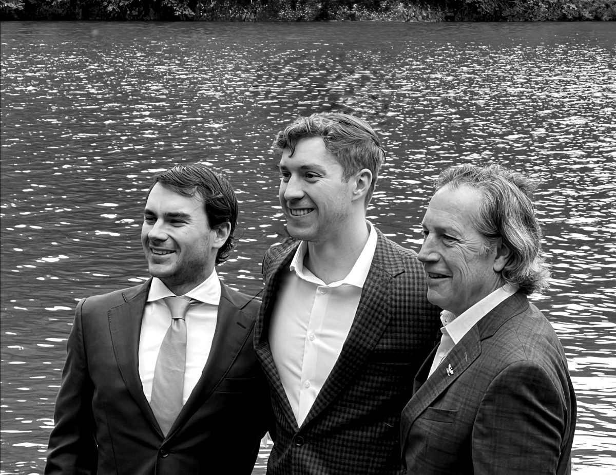 Jake, Joseph, and Lew Eisaguirre standing together at the water's edge